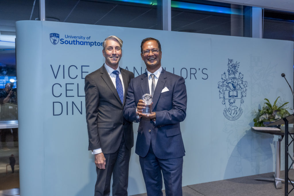 Dr S Chelvan holding his Lifetime Achievement Award and standing next to his husband, Mark Chelvan-Stanmore at the Vice-Chancellor's Celebration Dinner